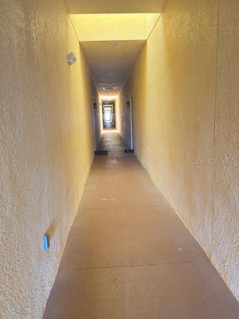 hallway featuring a textured wall