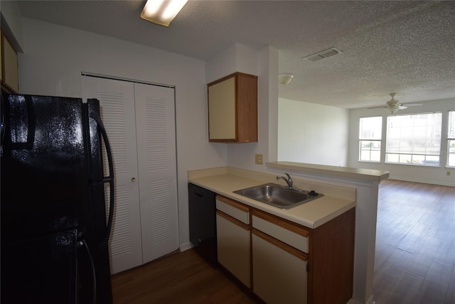 1075 S Hiawassee Rd Unit 916, Orlando, FL 32835 - kitchen featuring a peninsula, black appliances, dark wood-style flooring, light countertops, and a sink