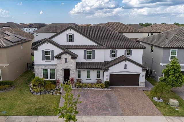 8109 Ludington Cir, Orlando, FL 32836 - view of front of home featuring a tiled roof, stone siding, stucco siding, a front lawn, and decorative driveway