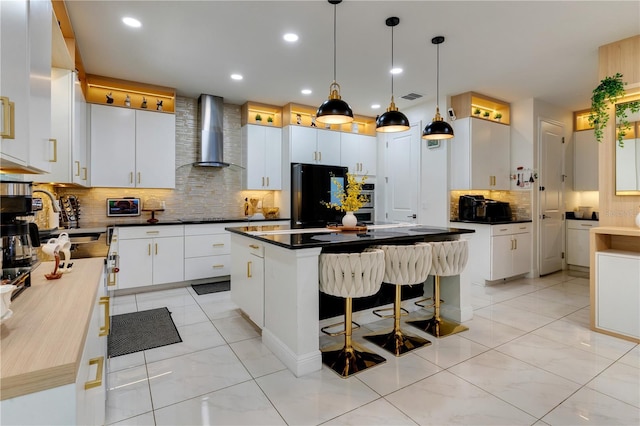 8109 Ludington Cir, Orlando, FL 32836 - kitchen with wall chimney range hood, dark countertops, black appliances, visible vents, and a sink