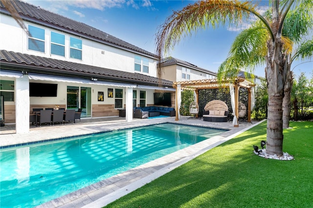 8109 Ludington Cir, Orlando, FL 32836 - rear view of house featuring a patio, a pergola, an outdoor hangout area, a tiled roof, and a lawn