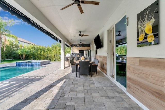 8109 Ludington Cir, Orlando, FL 32836 - view of patio with a pool with connected hot tub, a ceiling fan, outdoor dining area, and an outdoor kitchen
