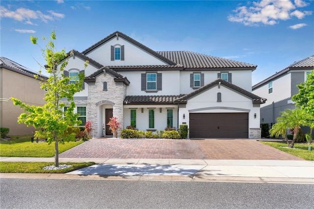 8109 Ludington Cir, Orlando, FL 32836 - mediterranean / spanish-style house featuring a tile roof, decorative driveway, and stucco siding