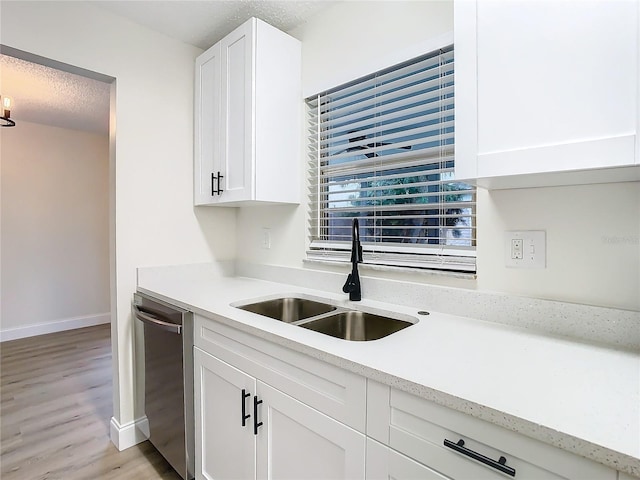 7400 Mitchell Ranch Rd, New Port Richey, FL 34655 - kitchen with a sink, dishwasher, light wood finished floors, white cabinets, and baseboards