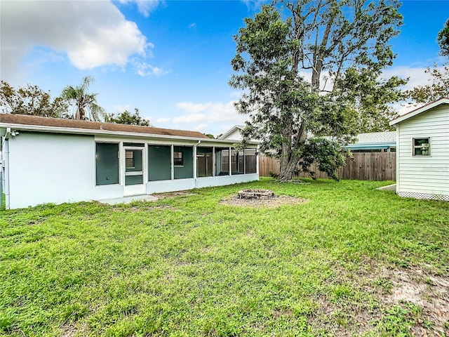 7400 Mitchell Ranch Rd, New Port Richey, FL 34655 - view of yard with an outdoor fire pit and a sunroom