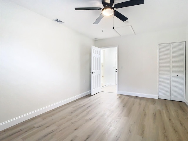 7400 Mitchell Ranch Rd, New Port Richey, FL 34655 - unfurnished bedroom featuring light wood finished floors, baseboards, a closet, and ceiling fan