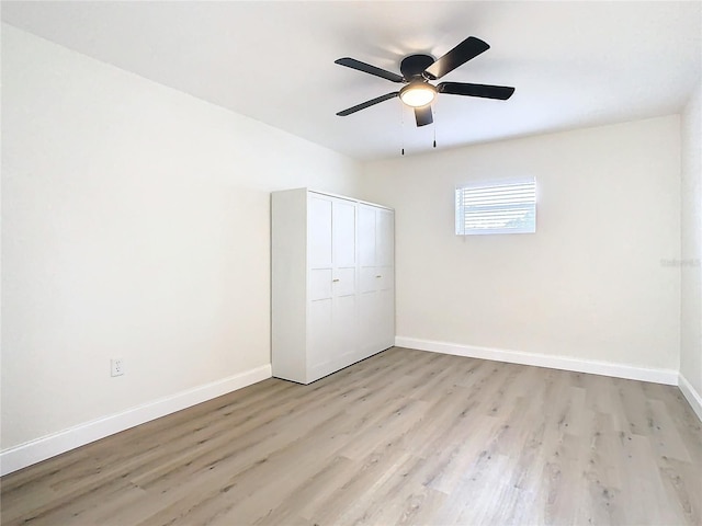 7400 Mitchell Ranch Rd, New Port Richey, FL 34655 - unfurnished bedroom with light wood-style floors, baseboards, a closet, and a ceiling fan