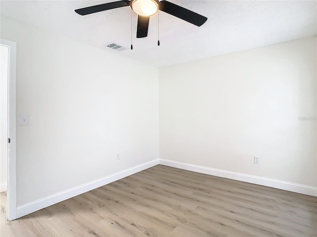 7400 Mitchell Ranch Rd, New Port Richey, FL 34655 - unfurnished room featuring wood finished floors, ceiling fan, and baseboards
