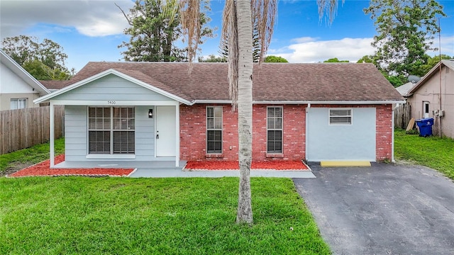 7400 Mitchell Ranch Rd, New Port Richey, FL 34655 - view of front facade featuring brick siding and a shingled roof