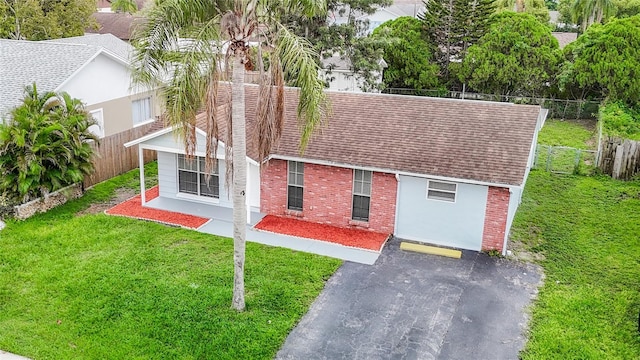7400 Mitchell Ranch Rd, New Port Richey, FL 34655 - view of front facade with a shingled roof and brick siding