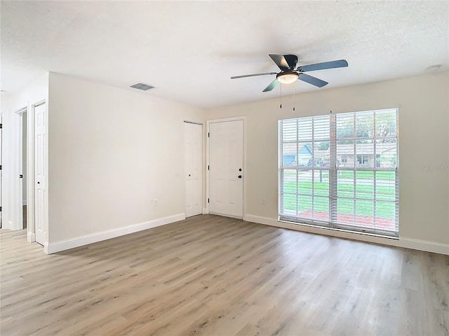 7400 Mitchell Ranch Rd, New Port Richey, FL 34655 - unfurnished room with wood finished floors, baseboards, and a ceiling fan