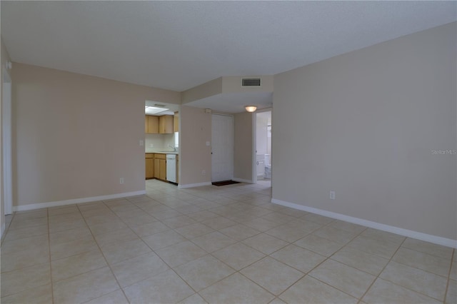 empty room with visible vents, baseboards, and light tile patterned floors