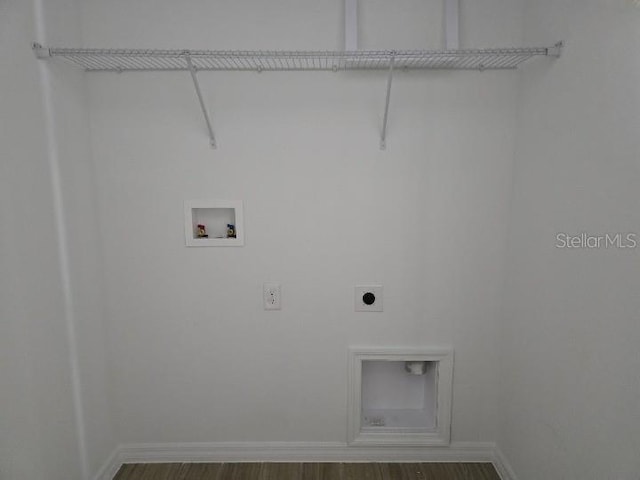 2976 Embark Trl, Saint Cloud, FL 34771 - washroom featuring hookup for an electric dryer, washer hookup, wood finished floors, and baseboards