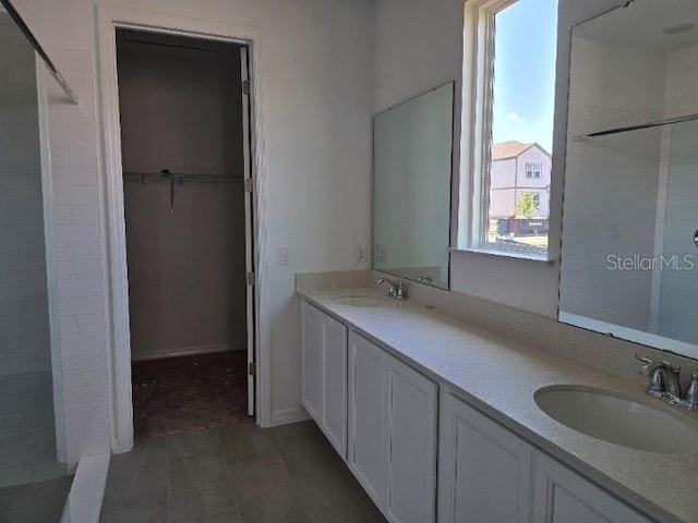 2976 Embark Trl, Saint Cloud, FL 34771 - bathroom featuring tiled shower, double vanity, and a spacious closet