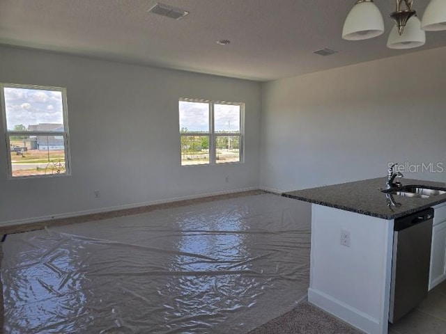 2976 Embark Trl, Saint Cloud, FL 34771 - kitchen with a sink, stainless steel dishwasher, dark stone countertops, and baseboards