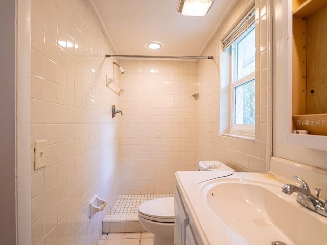 full bathroom featuring vanity, ornamental molding, toilet, tiled shower, and tile walls