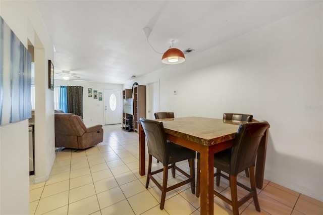 9231 Ventana Ln, Orlando, FL 32825 - dining area with light tile patterned floors, visible vents, baseboards, and a ceiling fan