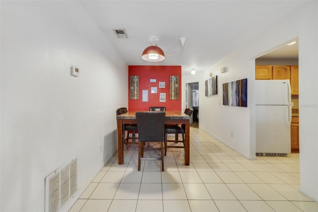 9231 Ventana Ln, Orlando, FL 32825 - dining area featuring light tile patterned floors, visible vents, and baseboards