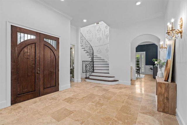 6143 Cartmel Ln, Windermere, FL 34786 - foyer entrance with arched walkways, crown molding, recessed lighting, stairs, and a chandelier