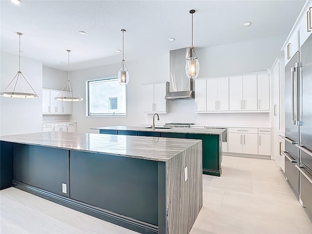1080 E Jack Nicklaus Ct, Kissimmee, FL 34747 - kitchen with a spacious island, wall chimney exhaust hood, a sink, recessed lighting, and stainless steel built in refrigerator