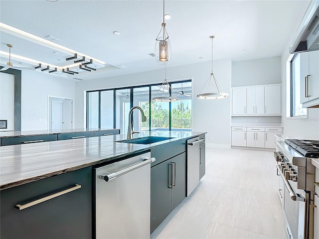 1080 E Jack Nicklaus Ct, Kissimmee, FL 34747 - kitchen with a sink, appliances with stainless steel finishes, pendant lighting, white cabinetry, and modern cabinets