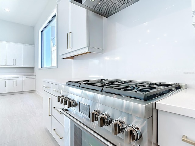 1080 E Jack Nicklaus Ct, Kissimmee, FL 34747 - kitchen with high end stainless steel range, light countertops, white cabinetry, and modern cabinets