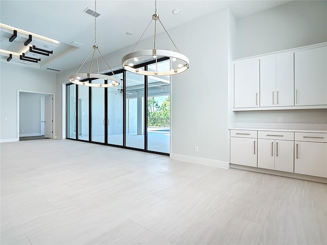 1080 E Jack Nicklaus Ct, Kissimmee, FL 34747 - unfurnished dining area featuring a chandelier, baseboards, and a towering ceiling