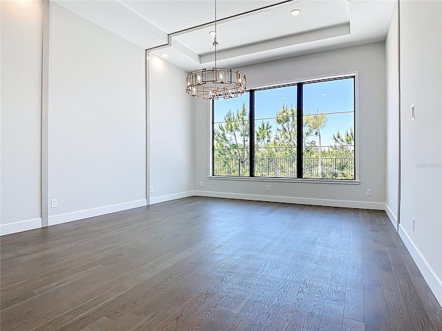 1080 E Jack Nicklaus Ct, Kissimmee, FL 34747 - spare room with a tray ceiling, dark wood-type flooring, a chandelier, baseboards, and recessed lighting