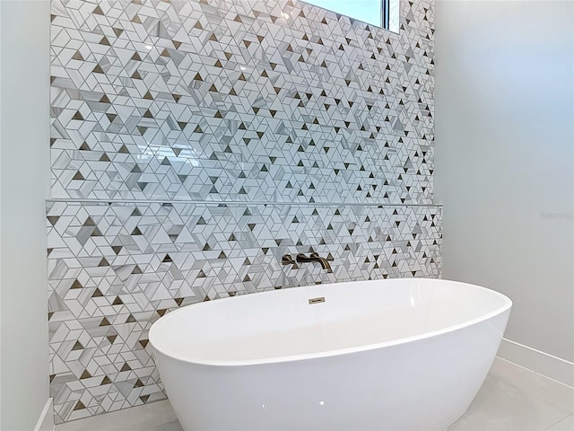 1080 E Jack Nicklaus Ct, Kissimmee, FL 34747 - bathroom featuring tile patterned flooring, a soaking tub, and tile walls