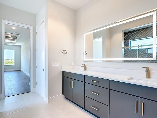 1080 E Jack Nicklaus Ct, Kissimmee, FL 34747 - bathroom with baseboards, double vanity, and tile patterned flooring