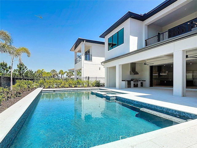 1080 E Jack Nicklaus Ct, Kissimmee, FL 34747 - view of pool with fence, a patio, ceiling fan, an outdoor kitchen, and a pool with connected hot tub