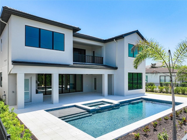1080 E Jack Nicklaus Ct, Kissimmee, FL 34747 - back of property with a patio area, stucco siding, a balcony, and fence