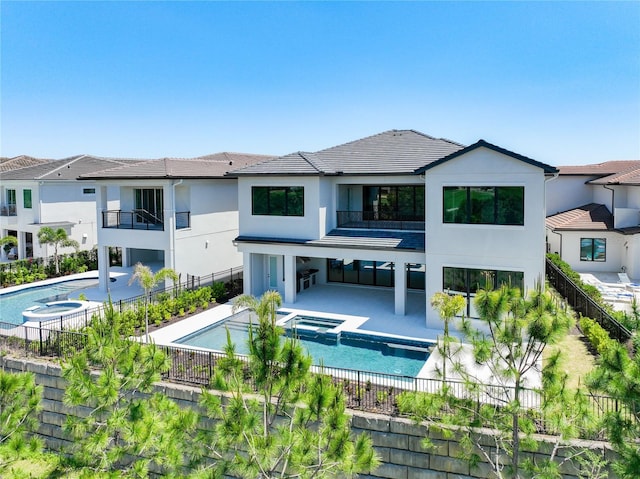 1080 E Jack Nicklaus Ct, Kissimmee, FL 34747 - back of house featuring a balcony, stucco siding, a fenced backyard, and a patio area