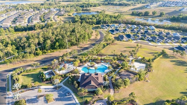 birds eye view of property with a water view and a residential view