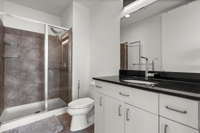 full bathroom featuring toilet, a stall shower, vanity, and tile patterned flooring