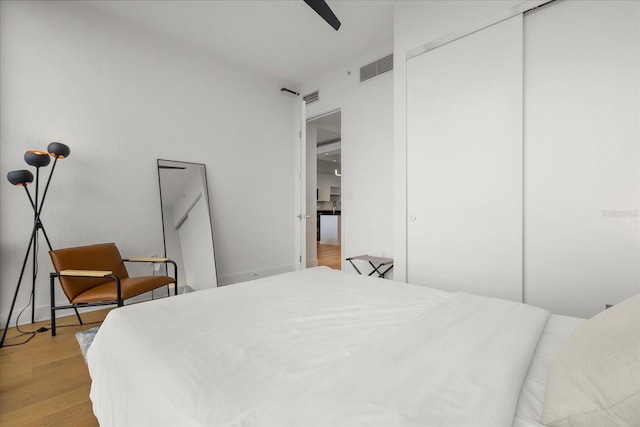 bedroom with light wood-style floors and a closet