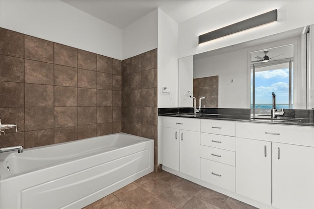 full bathroom with a garden tub, a ceiling fan, double vanity, and tile patterned floors