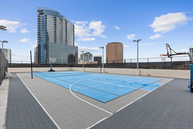 view of basketball court featuring community basketball court and fence