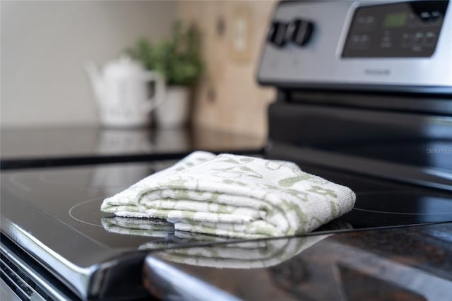 interior details featuring stainless steel range with electric stovetop