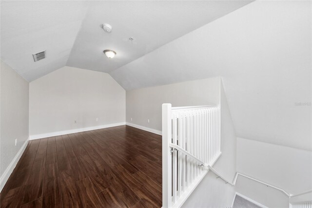 bonus room with visible vents, baseboards, wood finished floors, and lofted ceiling