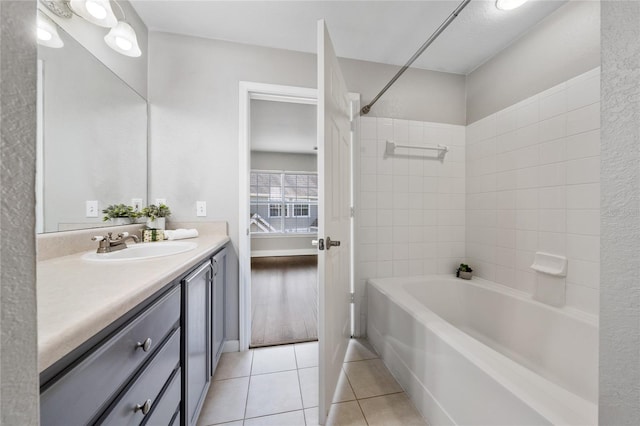 full bath featuring tile patterned floors, shower / bathing tub combination, and vanity