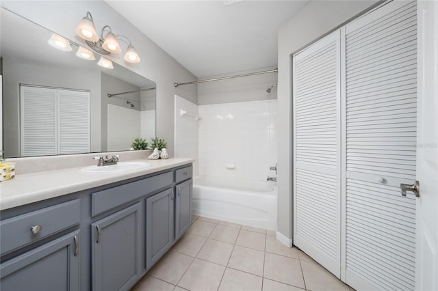 full bathroom with a closet, tile patterned floors, vanity, and  shower combination