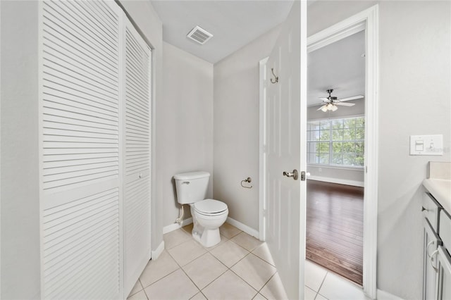 bathroom featuring a closet, baseboards, tile patterned flooring, toilet, and visible vents