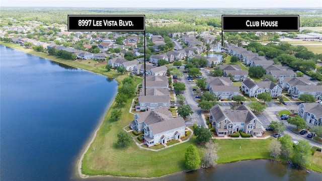 drone / aerial view featuring a water view and a residential view