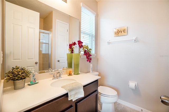 3041 Cardillino Way, Kissimmee, FL 34741 - full bathroom with toilet, vanity, baseboards, and a shower with door