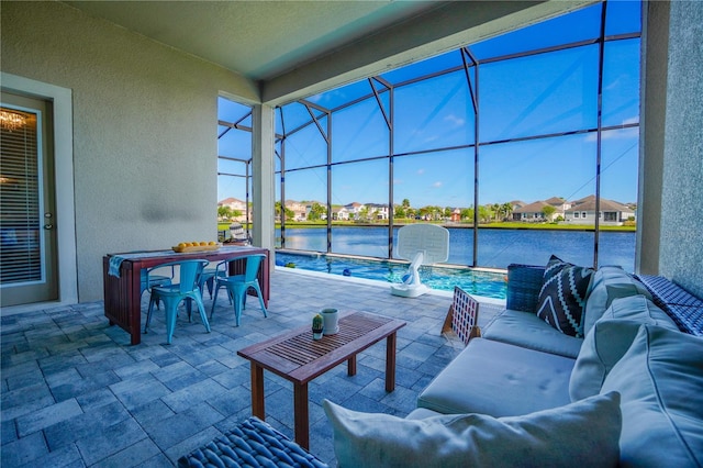 3041 Cardillino Way, Kissimmee, FL 34741 - view of patio / terrace with a water view, outdoor dining space, glass enclosure, and an outdoor hangout area
