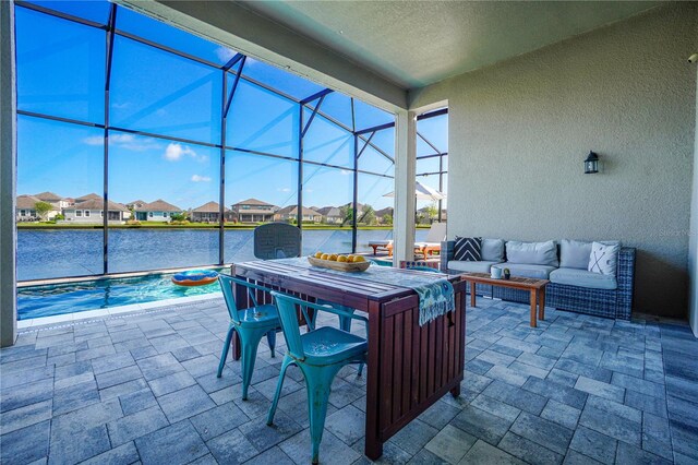 3041 Cardillino Way, Kissimmee, FL 34741 - view of patio / terrace with an outdoor living space, an outdoor pool, a water view, a lanai, and a residential view