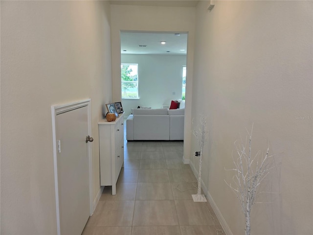 1764 Stamen Dr, Kissimmee, FL 34744 - hallway with light tile patterned floors and baseboards