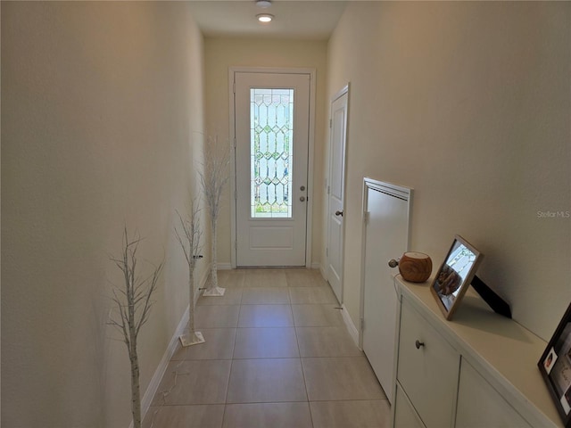 1764 Stamen Dr, Kissimmee, FL 34744 - doorway with light tile patterned floors and baseboards