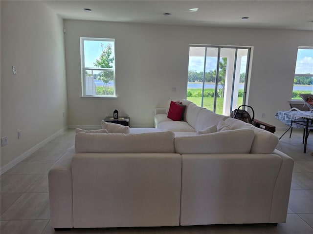 1764 Stamen Dr, Kissimmee, FL 34744 - living room featuring a water view, baseboards, and light tile patterned flooring